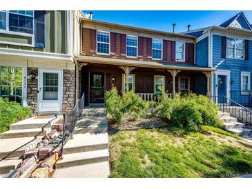 Charming townhome with a covered front porch and well-maintained landscaping at 8231 S Fillmore Way, Centennial, CO 80122