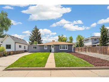 Charming home with a lush lawn, sidewalk and manicured landscape at 309 W Oak St, Lafayette, CO 80026