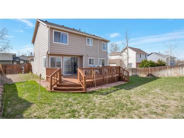 Spacious backyard with a large wooden deck, perfect for outdoor entertaining and relaxation at 12134 Glencoe St, Thornton, CO 80241