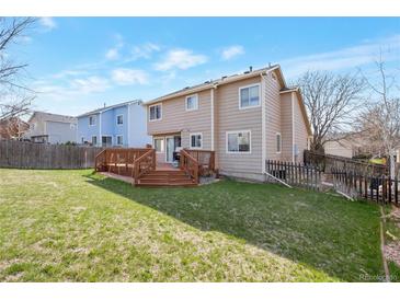 A spacious backyard with a large wooden deck perfect for entertaining and enjoying the outdoors at 12134 Glencoe St, Thornton, CO 80241