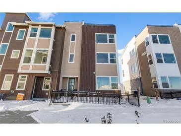 Modern townhouse with a mix of brick and siding, and a convenient front ramp for accessibility at 14245 Currant St, Broomfield, CO 80020