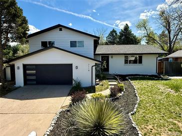 Charming two-story home boasting black trim, modern garage door and meticulous landscaping in a beautiful suburban neighborhood at 7114 S Costilla St, Littleton, CO 80120
