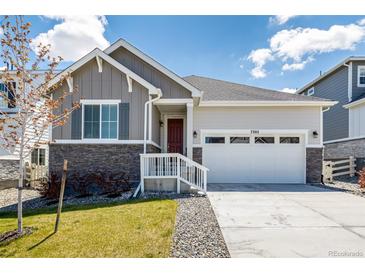 Charming single-Gathering home featuring a well-manicured lawn, two-car garage, and inviting front entrance at 7202 S Valleyhead Ct, Aurora, CO 80016