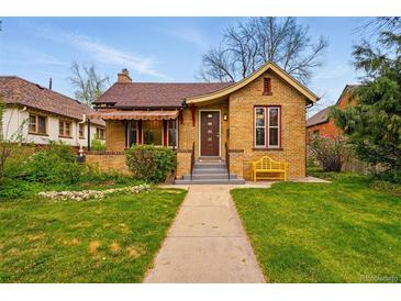 Charming brick home featuring a well-manicured lawn and a welcoming yellow bench at 1312 Ash St, Denver, CO 80220