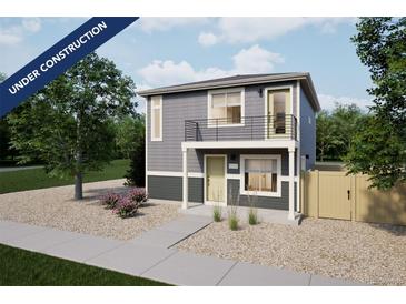 Modern two-story home with gray siding, a small balcony, and low maintenance gravel landscaping at 46517 Avery Ln, Bennett, CO 80102