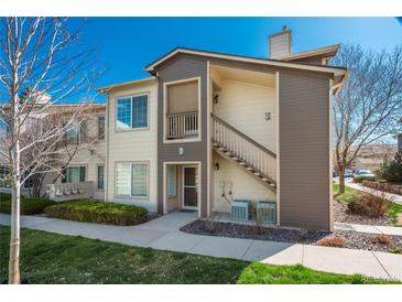 Inviting two-story condo featuring neutral siding, a private entrance, and well-maintained landscaping at 8775 W Berry Ave # 101, Littleton, CO 80123