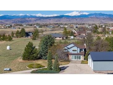 Charming home with mountain views, boasting a large yard and a barn-style detached garage at 2610 W County Road 4, Berthoud, CO 80513