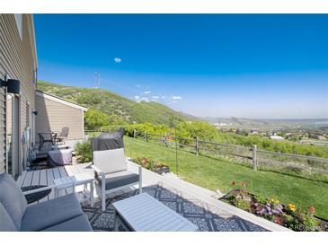 Enjoy outdoor living on this beautiful patio with mountain views, a grill, and comfortable seating at 6980 Fargo Trl, Littleton, CO 80125