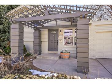 Charming front entry with pergola and a well-manicured landscape at 7240 S Cherry Dr, Centennial, CO 80122