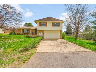 Charming two-story home featuring a large front yard, attached garage and beautiful curb appeal at 8204 S Cody St, Littleton, CO 80128