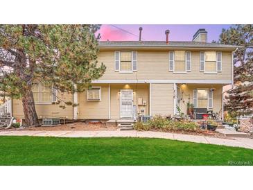 Charming two-story townhome with a well-manicured lawn and classic architectural details, providing a warm, welcoming curb appeal at 4038 S Richfield Way, Aurora, CO 80013