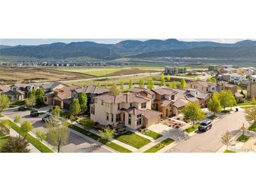 Stunning aerial view of a suburban neighborhood with well-maintained lawns and mountain views at 15218 W La Salle Ave, Lakewood, CO 80228
