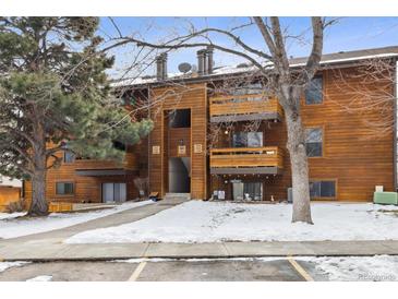 Attractive exterior of a wood-sided multi-unit building with parking and landscaping at 337 Wright St # 207, Lakewood, CO 80228