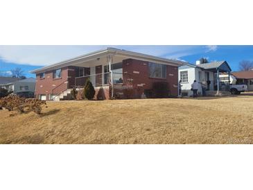 Charming brick home with a covered porch and a well-maintained front yard, ideal for suburban living at 3601 W 80Th Ave, Westminster, CO 80031