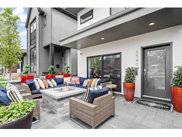 Inviting front porch with comfortable seating around a stone fire pit at 3540 Pecos St, Denver, CO 80211