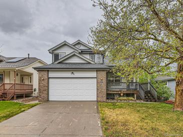 Charming two-story home with a brick-accented garage and inviting front porch at 11851 Elm Dr, Thornton, CO 80233