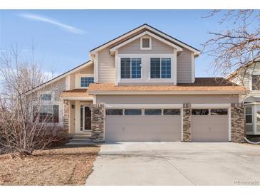 Charming two-story home featuring a three-car garage and neutral-colored siding, enhancing its curb appeal at 5857 S Zante Cir, Aurora, CO 80015