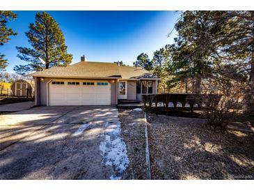 Charming single-Gathering home with a two-car garage and well-maintained front yard surrounded by mature trees at 36635 View Ridge Dr, Elizabeth, CO 80107