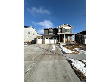 Charming two-story home with a three car garage and well-maintained front yard at 7435 E 159Th Pl, Thornton, CO 80602