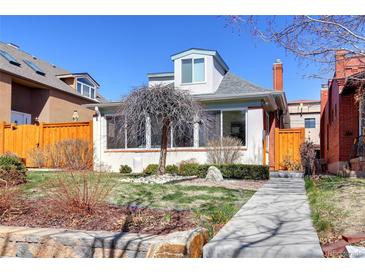 Charming home featuring a well-manicured front yard, complemented by a unique decorative tree and a cozy, inviting walkway at 4729 W 32Nd Ave, Denver, CO 80212