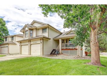 Charming two-story home featuring a well-manicured lawn and a welcoming front porch at 5185 E Weaver Dr, Centennial, CO 80121