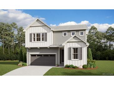 Charming two-story home featuring gray and white exterior with a two-car garage and inviting curb appeal at 9051 Telluride Ct, Commerce City, CO 80022