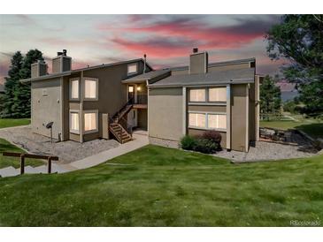 Inviting exterior view of a two-story condo featuring well-kept landscaping and a private entrance at 1140 Magic Lamp Way # 4, Monument, CO 80132