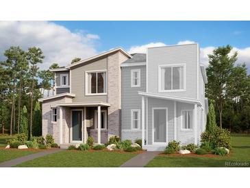 Modern townhome with brick and siding exterior, front porch, and well-manicured landscaping at 24118 E Warm Springs Ave, Aurora, CO 80019