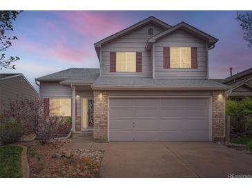 Charming two-story home with a two-car garage, red shutters, and low maintenance rock landscaping at 5130 S Wenatchee St, Aurora, CO 80015