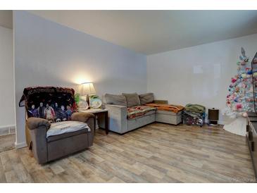 Cozy living room featuring hardwood floors and ample seating at 6651 Albion St, Commerce City, CO 80022