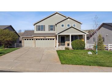 Charming two-story home featuring a three-car garage and well-manicured front yard at 3978 Aspen Hollow Ct, Castle Rock, CO 80104