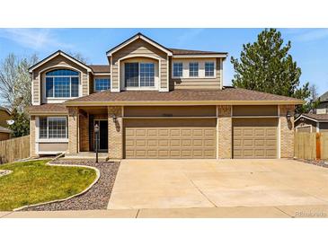 Charming two-story home with a three-car garage and well-maintained landscaping at 19061 E Powers Pl, Aurora, CO 80015