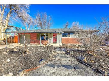 Charming single-story home featuring a brick facade, covered entryway, and well-maintained front yard at 5442 S Cedar St, Littleton, CO 80120