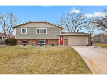 Ranch style home with attached garage and landscaped yard at 4531 S Iris St, Littleton, CO 80123