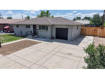 Charming single-story home with an attached garage and well-maintained landscaping at 235 N 12Th Ave, Brighton, CO 80601