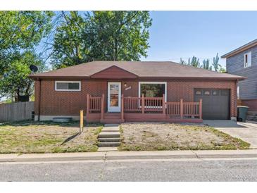 Brick ranch home with attached garage and front porch at 1104 Elmer Dr, Northglenn, CO 80233