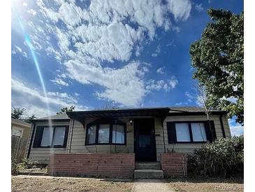 Charming single-story home featuring a manicured front yard and classic architectural details at 4995 N Beach Ct, Denver, CO 80221