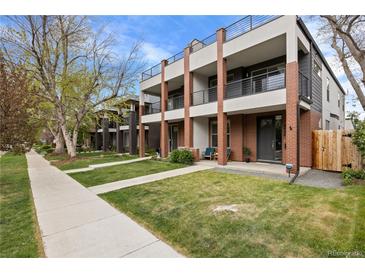 Modern townhomes with striking brick accents, balconies, and well-maintained lawns on a tree-lined street at 3928 Vrain St, Denver, CO 80212