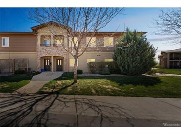Inviting condo exterior with well-manicured lawn and decorative stone accents enhancing the facade at 2215 Calais Dr # G, Longmont, CO 80504