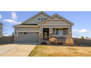 Charming home featuring a covered porch, stone accents, and a well-manicured front yard at 771 Dutton Ct, Castle Rock, CO 80104