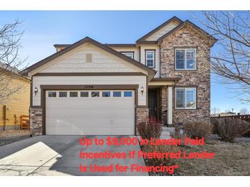 Charming two-story home featuring a stone facade, two-car garage, and well-maintained landscaping at 22336 E Bellewood Dr, Aurora, CO 80015