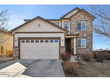 Charming two-story home featuring a stone facade, a two-car garage, and well-maintained landscaping at 22336 E Bellewood Dr, Centennial, CO 80015