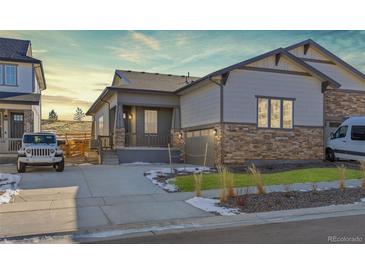 Attractive craftsman style home with stone accents and a 2-car garage at 17412 W 93Rd Pl, Arvada, CO 80007