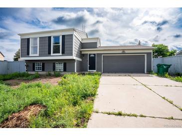 Inviting two-story home with gray siding, black door, and convenient two-car garage at 17863 Fringed Sage Way, Parker, CO 80134