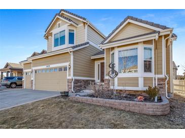 Charming two-story home with a two-car garage, manicured lawn, and lovely landscaping at 18150 Bolero Dr, Parker, CO 80134