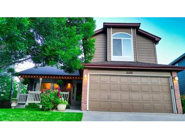 Charming two-story home featuring well-maintained front lawn, brick accents, and a spacious two-car garage at 5150 Morning Glory Pl, Highlands Ranch, CO 80130