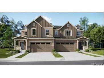 Beautiful two-story townhome with neutral siding, double garage, and well-manicured landscaping at 6740 Juniper Dr, Thornton, CO 80602
