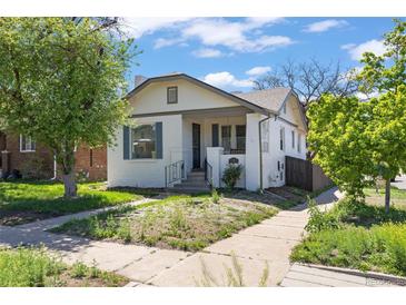 Charming white bungalow with a quaint front yard and inviting curb appeal, perfect for a starter home at 1901 S Lincoln St, Denver, CO 80210