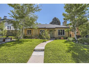Charming single-story home with a well-manicured lawn and inviting walkway at 2844 Bellaire St, Denver, CO 80207