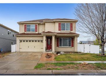 Charming two-story home featuring red shutters, a well-maintained lawn, and an attached two-car garage at 5293 Malaya St, Denver, CO 80249